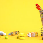 Grocery Shopping Cart With Food With Dropped Products. Inflation , Growth Of Market Basket Or Consumer Price Index Concept.